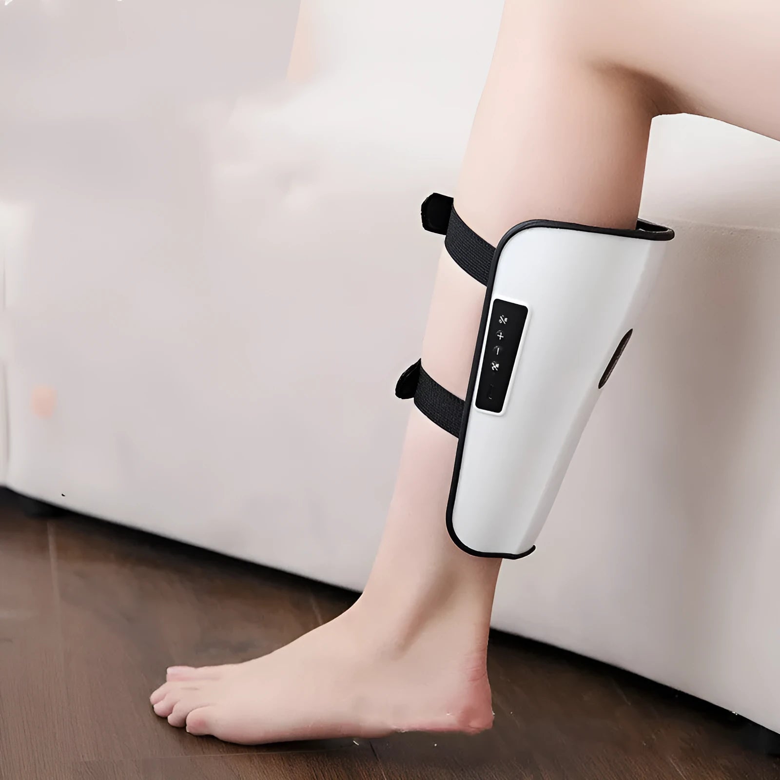 White plastic electronic calf massager with controls, showing USB Type-C port for charging.