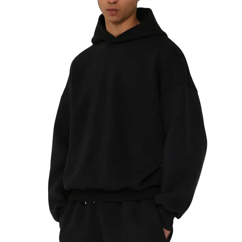 A man's grey fleece-lined cotton pullover hoodie on a hanger.
