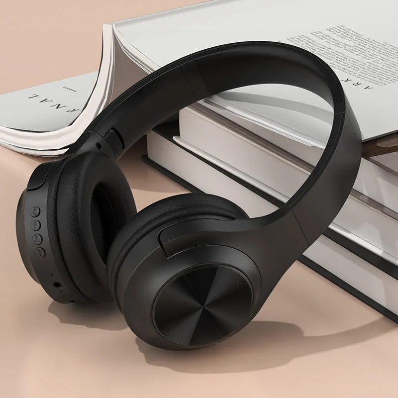 Creative wireless Bluetooth headset in chalk black, ivory white, or youth green colour on a charging stand