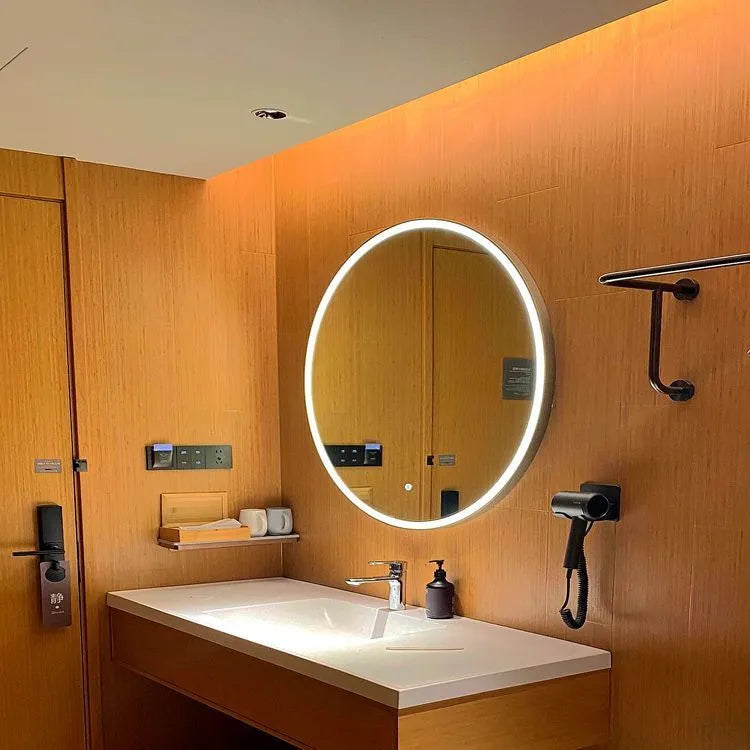 Round black frame bathroom mirror with LED lighting mounted on wall