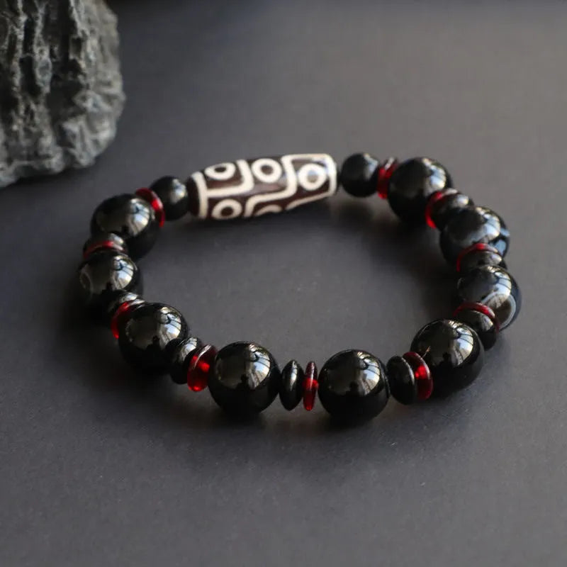 Hand-woven black agate and chalcedony dzi bead bracelet with geometric pattern