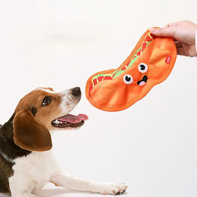 Hamburger-shaped dog chew toy with red, yellow and brown colours showing crinkle and squeak features