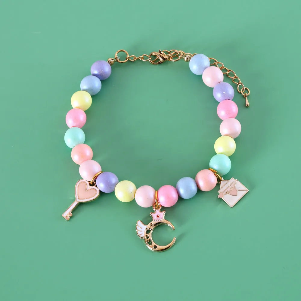 Colourful resin pet jewellery with moon and meteor motifs in macaron colours for dogs and cats