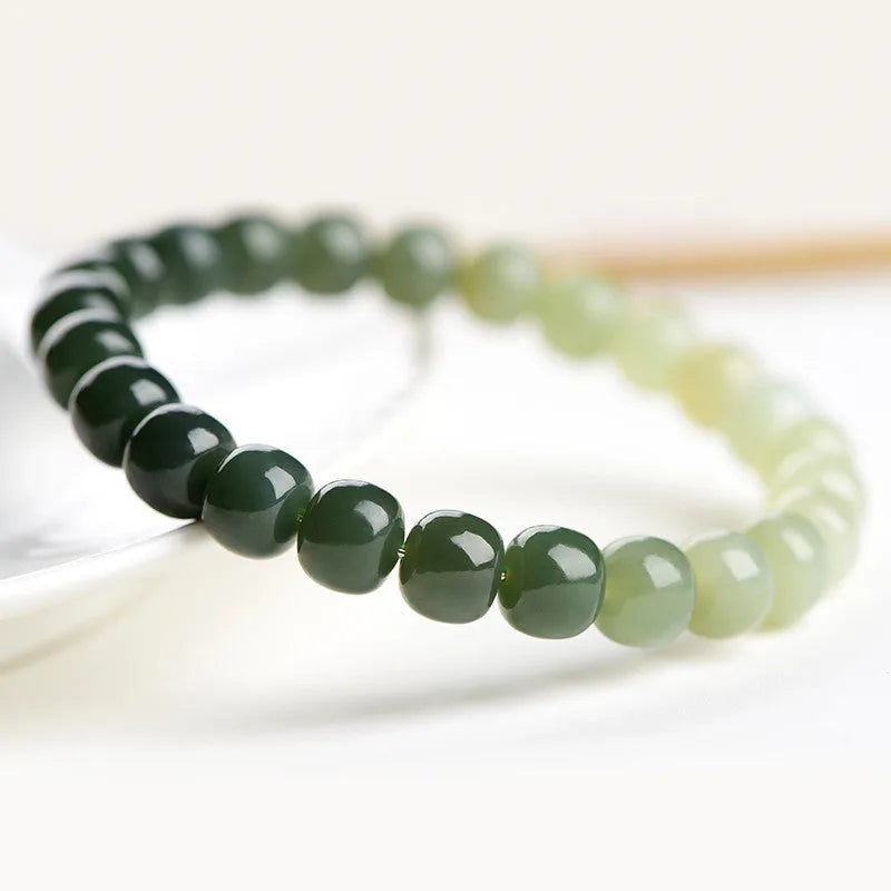 Polished Hetian jade bracelet with gradient clear water colour on wrist.