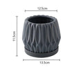 Grey small ceramic tabletop plant flowerpot on desktop with green plant