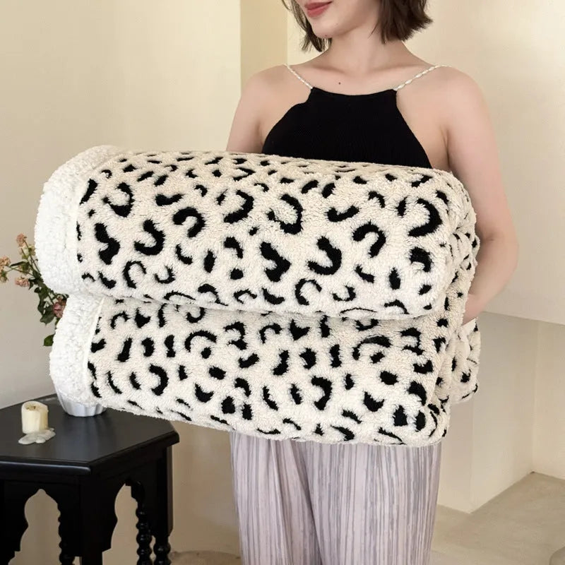 Double-layer leopard jacquard taffeta blanket in camel zebra pattern on a single bed.