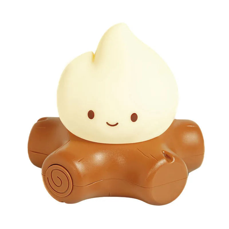 Silicone Small Fire Pile cartoon night lamp with yellow light on a surface