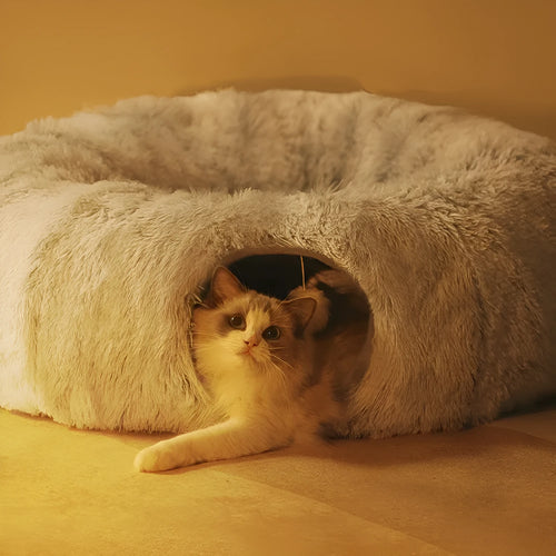 Closed cat tunnel nest 95cm made of long fluffy plush in rainbow colour on a wooden floor