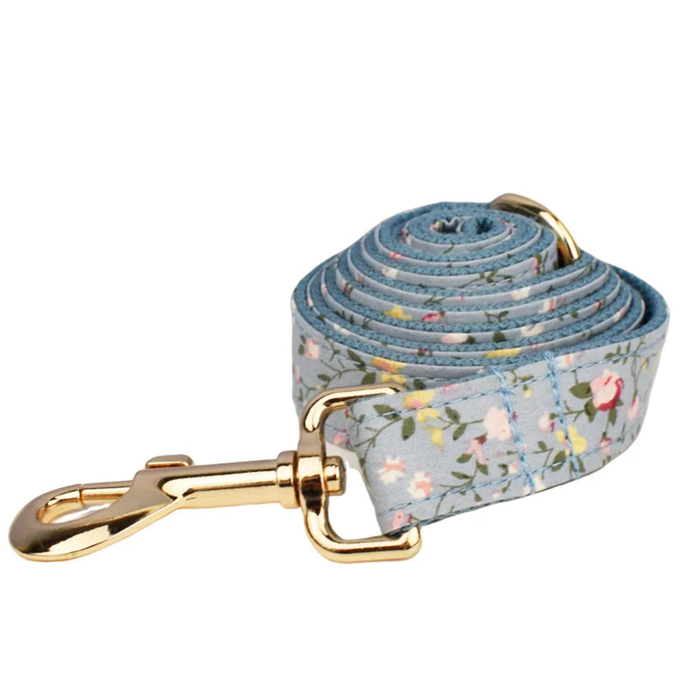 Floral polyester cotton dog collar set with matching leash, vest, bow, and poop bag accessories