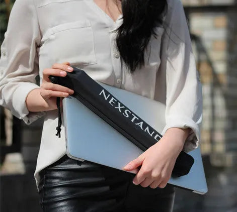 Black folding laptop stand made of reinforced nylon, shown in a compact folded size.