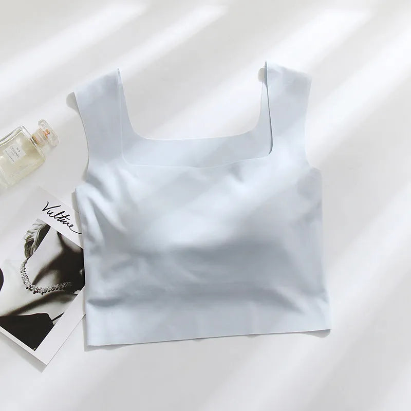Women's white seamless sling vest with built-in fixation cup and chest pad, shown from the back.