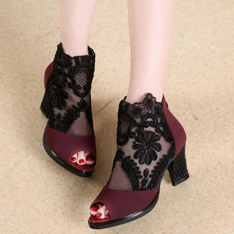 Black lace gladiator sandals for women with a square high heel and peep toe, showing zip closure.