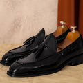 Men's black and brown genuine leather slip-on loafers with a pigskin lining, shown in multiple sizes.