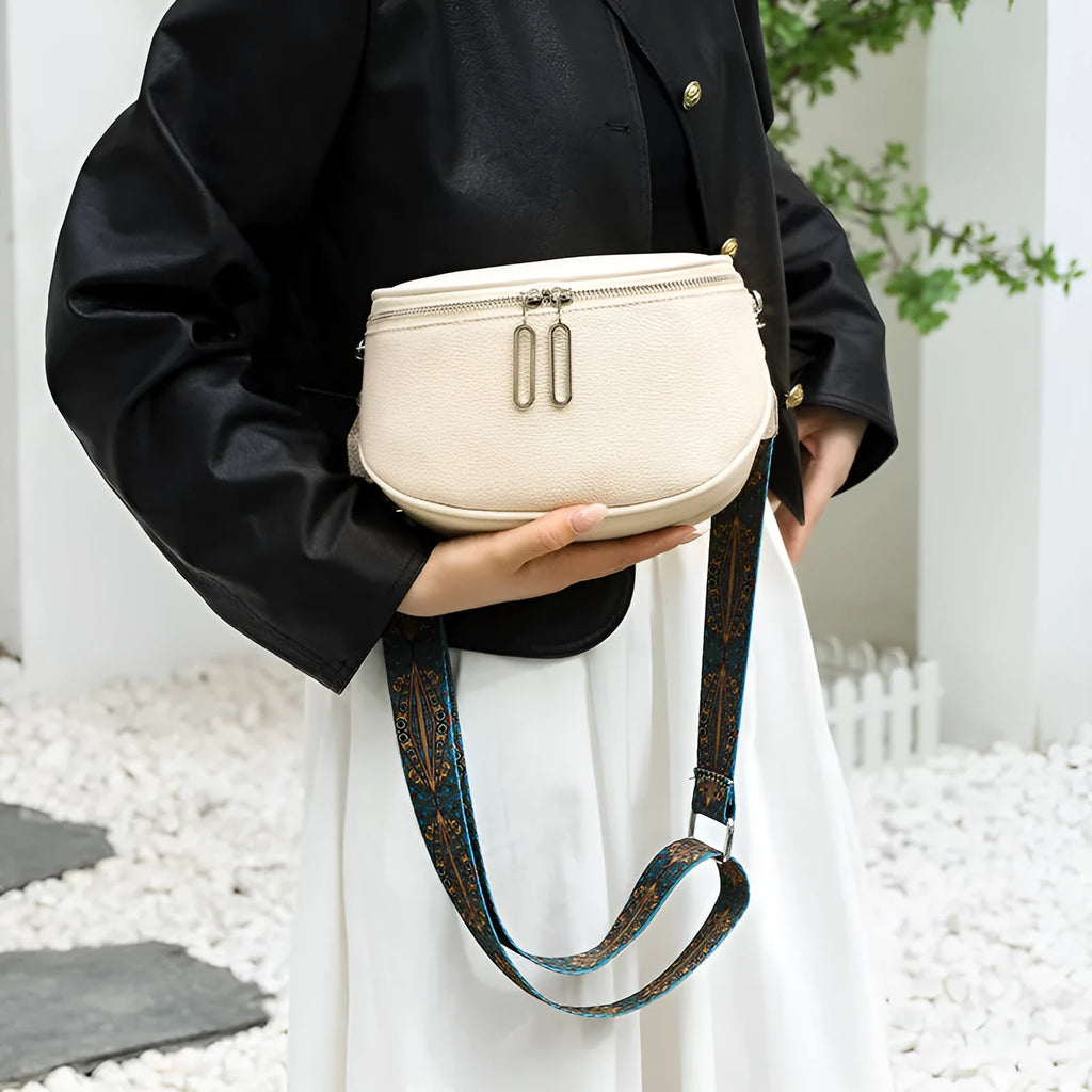 Women's soft PU leather messenger bag in saddle shape with crossbody strap and outer pocket