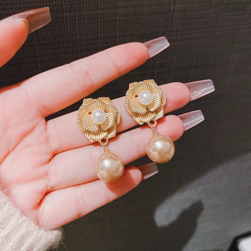 Gold electroplated sterling silver stud earrings with needle rose pearl design and opal stone accents