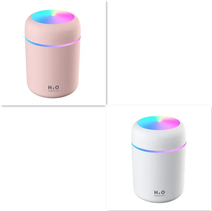 Pink USB portable humidifier with 300ml water tank on wooden desk surface