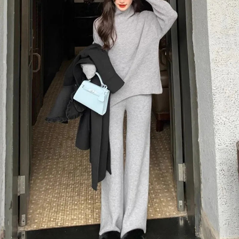 Women's beige acrylic sweater and wide-leg pants two-piece set laid flat.