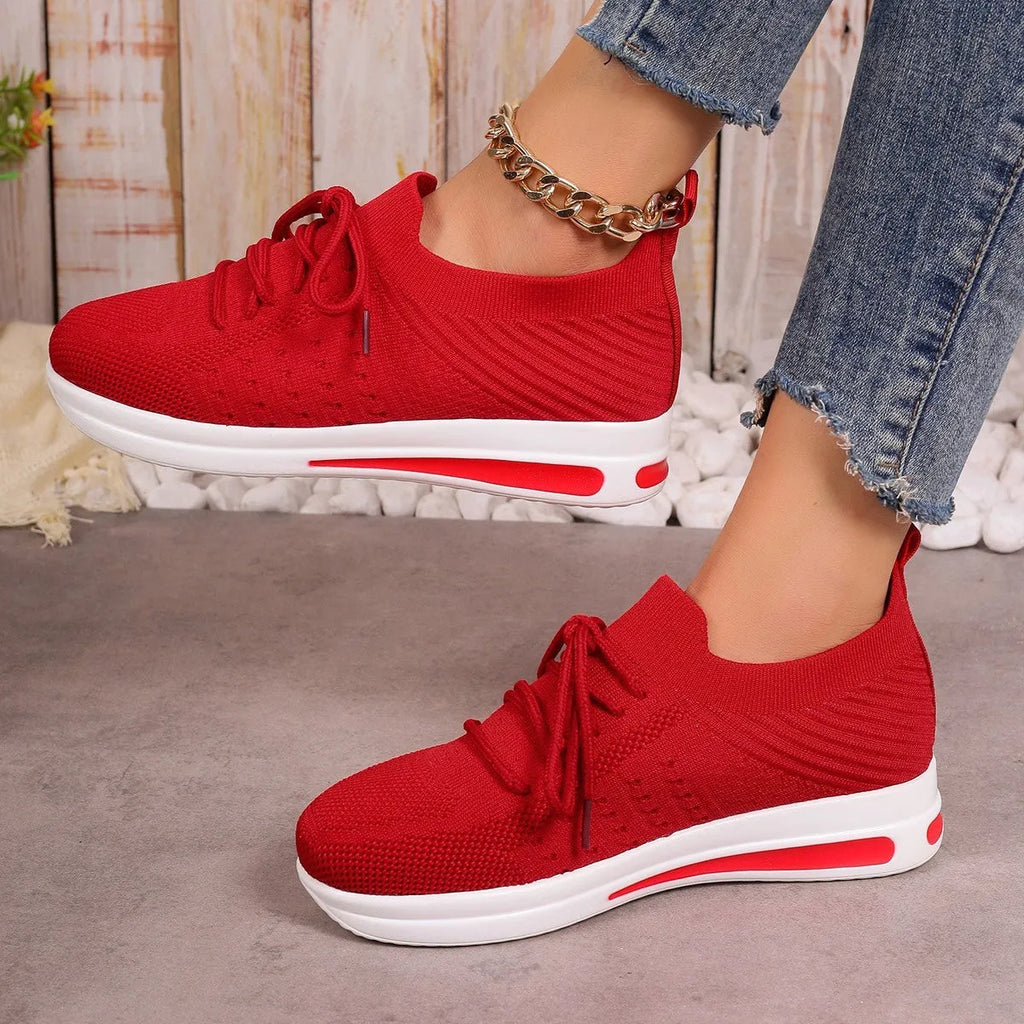 Women's low-top fly-knit sneakers in red colour with front lace-up closure and round-toe design