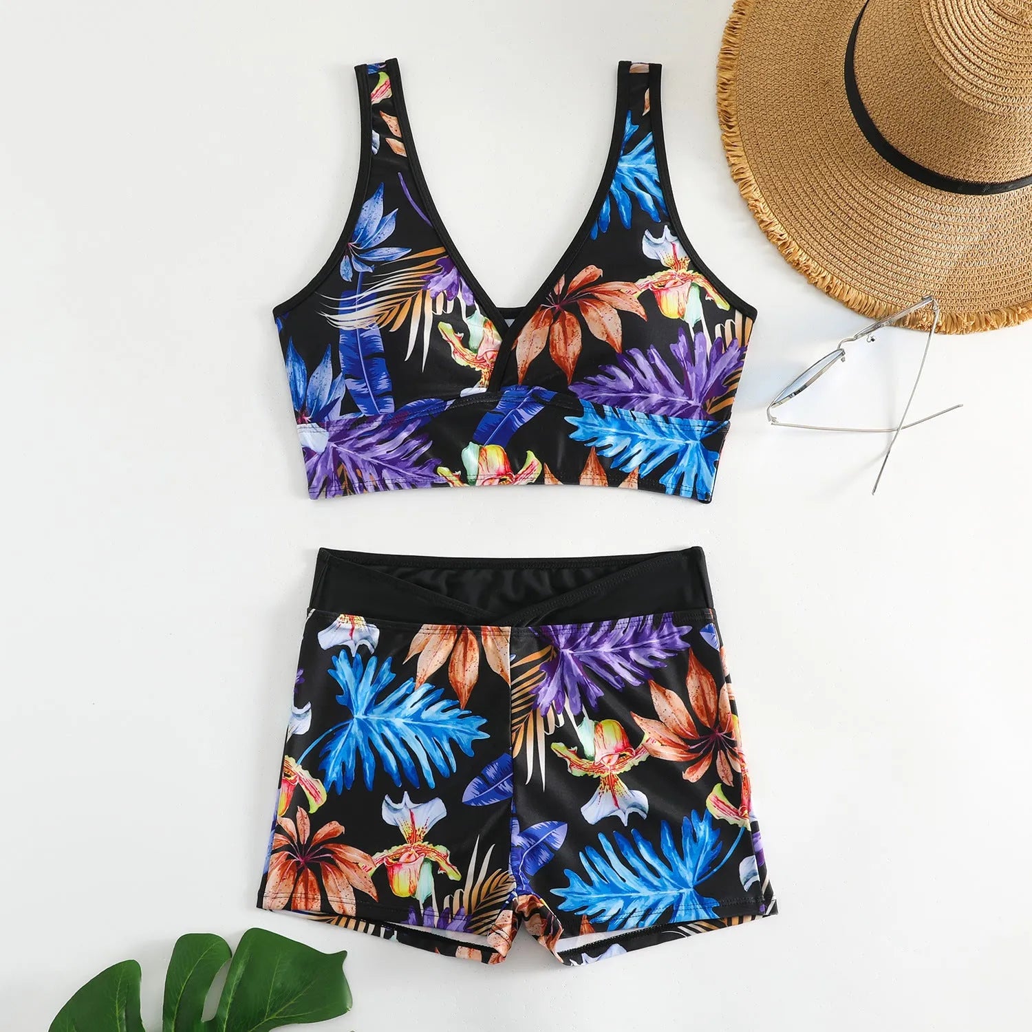 Women's two-piece printed swimsuit with high-neck top and boxer shorts in a multi-colour design.