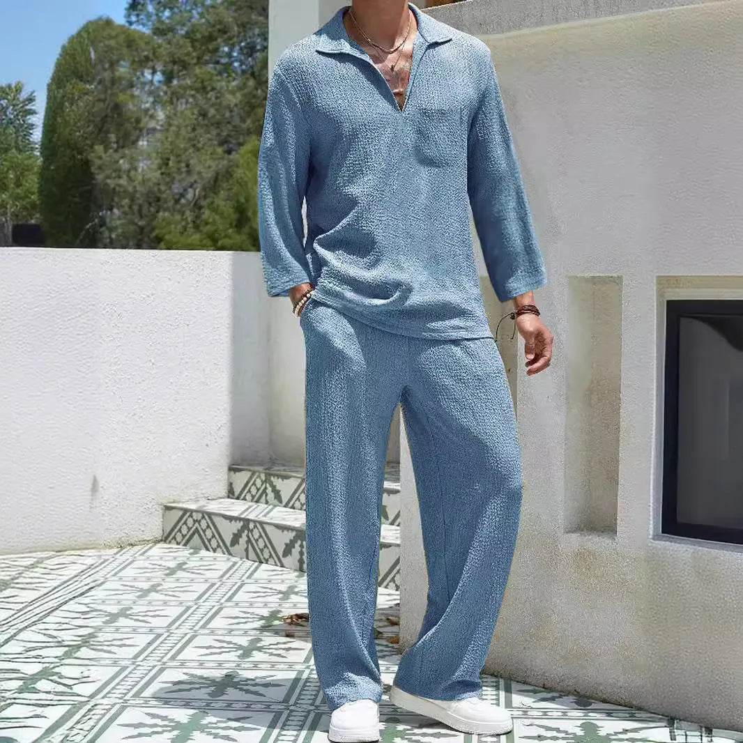 Man wearing a lake blue casual shirt and matching trousers from a polyester suit set.