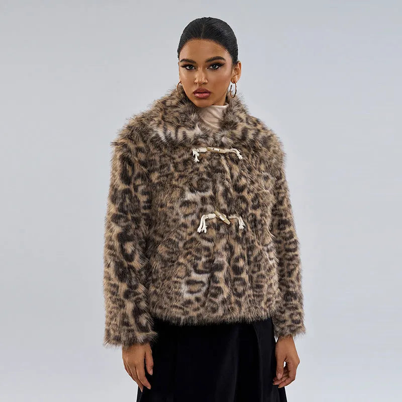Women's leopard print coat with a buckle lapel fastening, shown in street fashion style.