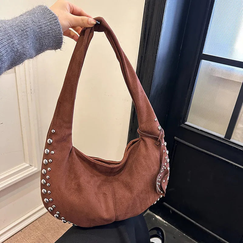 A soft plush underarm tote handbag in a retro style, shown in a colour option.