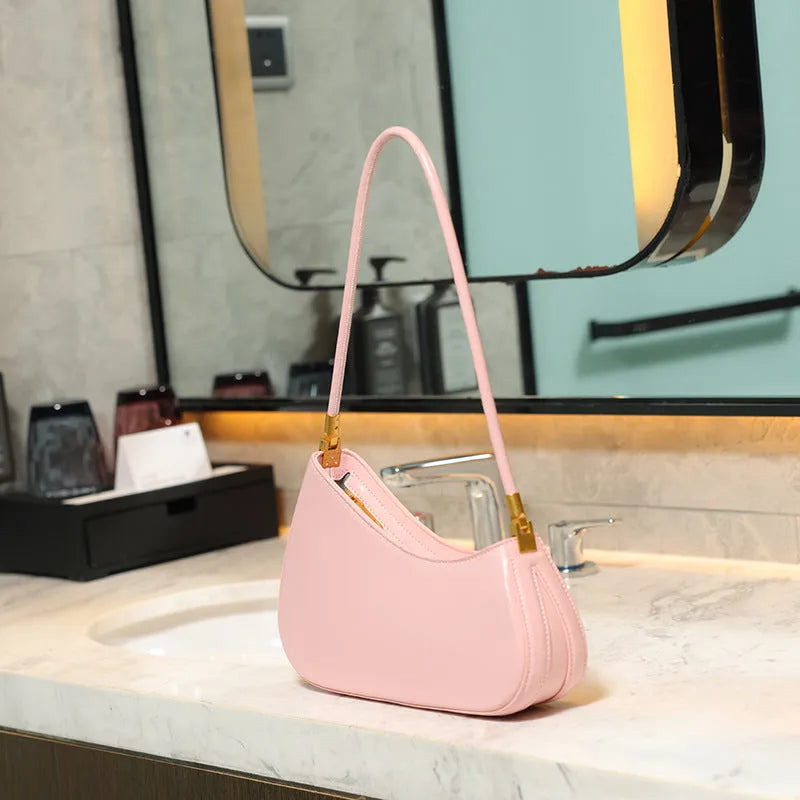 Retro oval women's underarm handbag in multiple colours, showing sandwich pocket design and single shoulder strap.