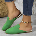 A pair of apricot-coloured mesh slip-on sandals with a cloth upper and flat rubber sole.