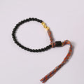 Hand-woven obsidian carrying strap bracelet showing textured weave and adjustable 15.5-16cm length