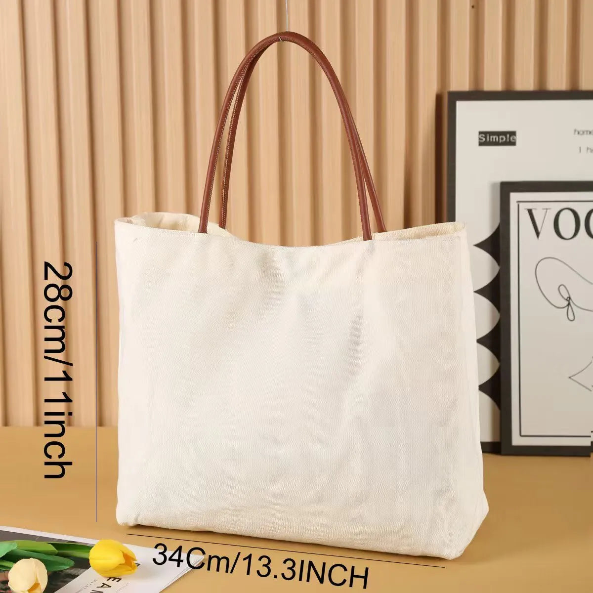 Heavyweight beige white canvas tote bag with reinforced handles on a plain background