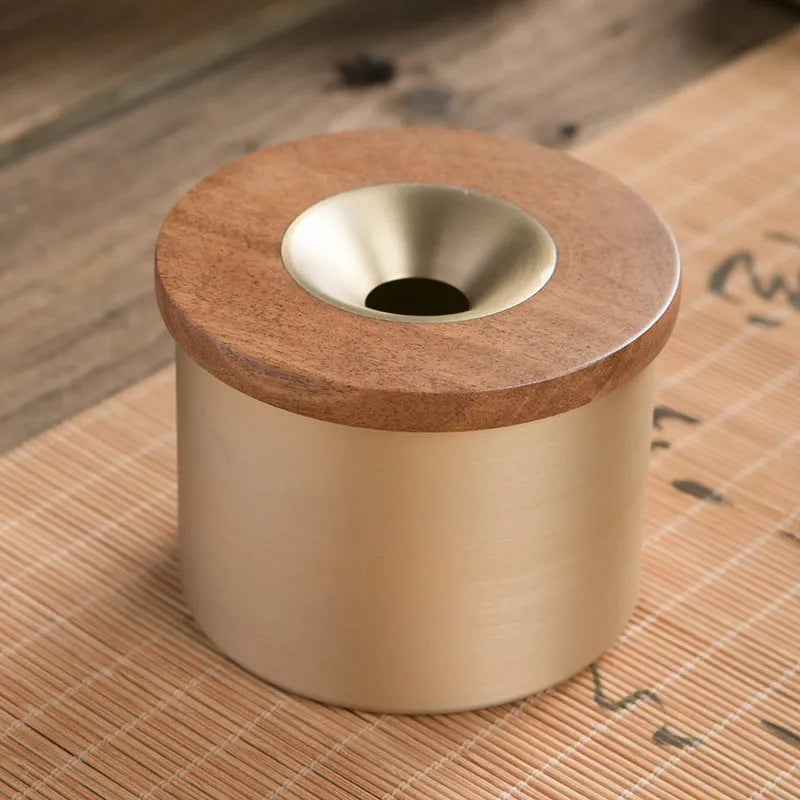 Brass retro ashtray with wooden lid in copper finish on living room table