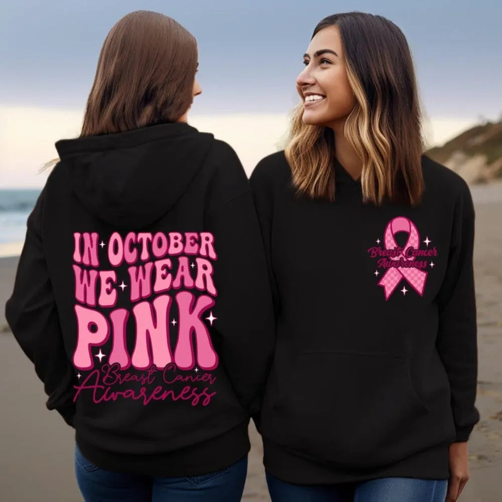 Women's pink breast cancer awareness pullover hoodie with retro graphic design and side seam pockets.