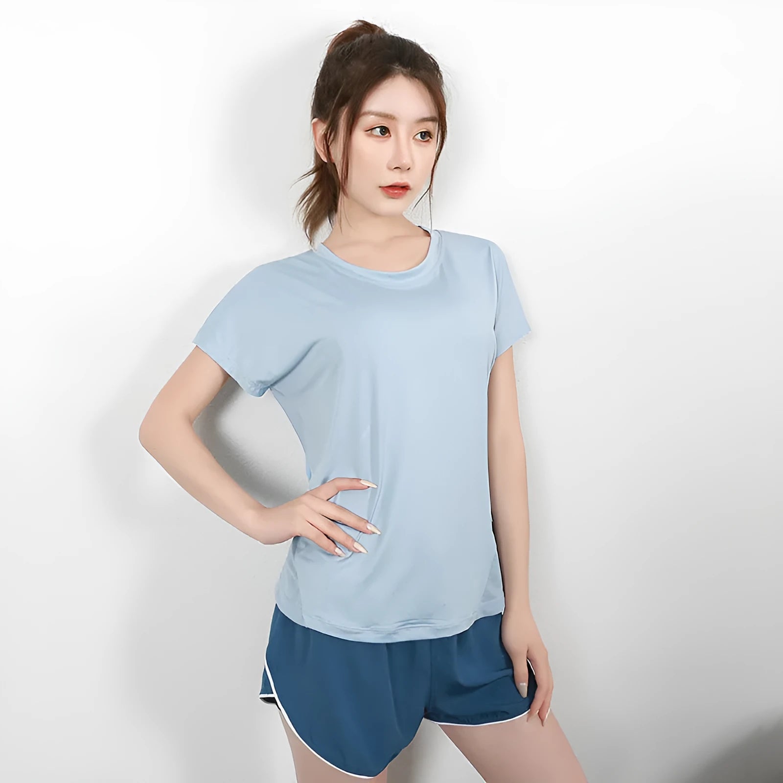 Women's short sleeve polyester fitness t-shirt in pink, shown for sports and gym wear.