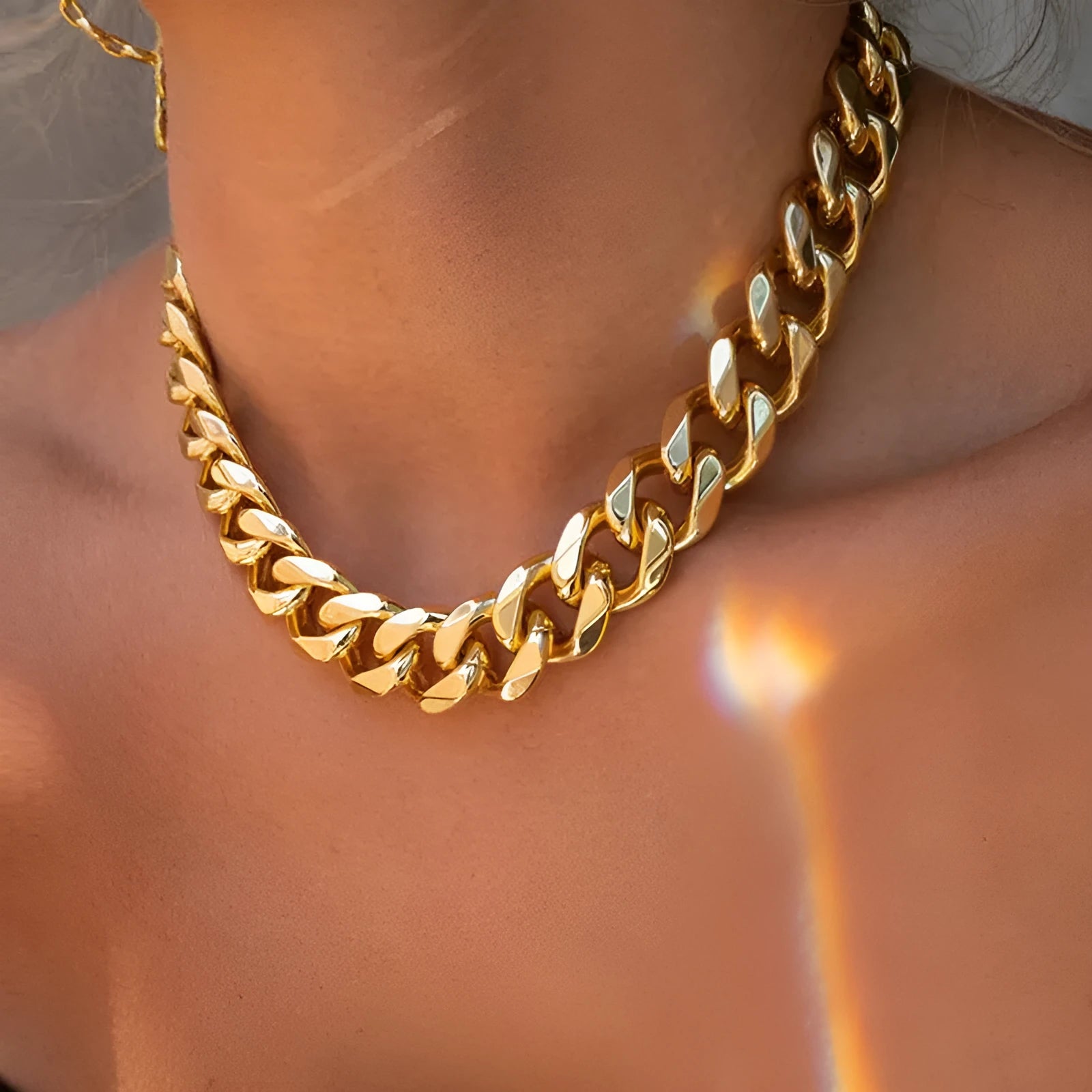 Gold-toned women's thick chain necklace with red accents, showing chunky 6cm wide links on a 32cm chain.