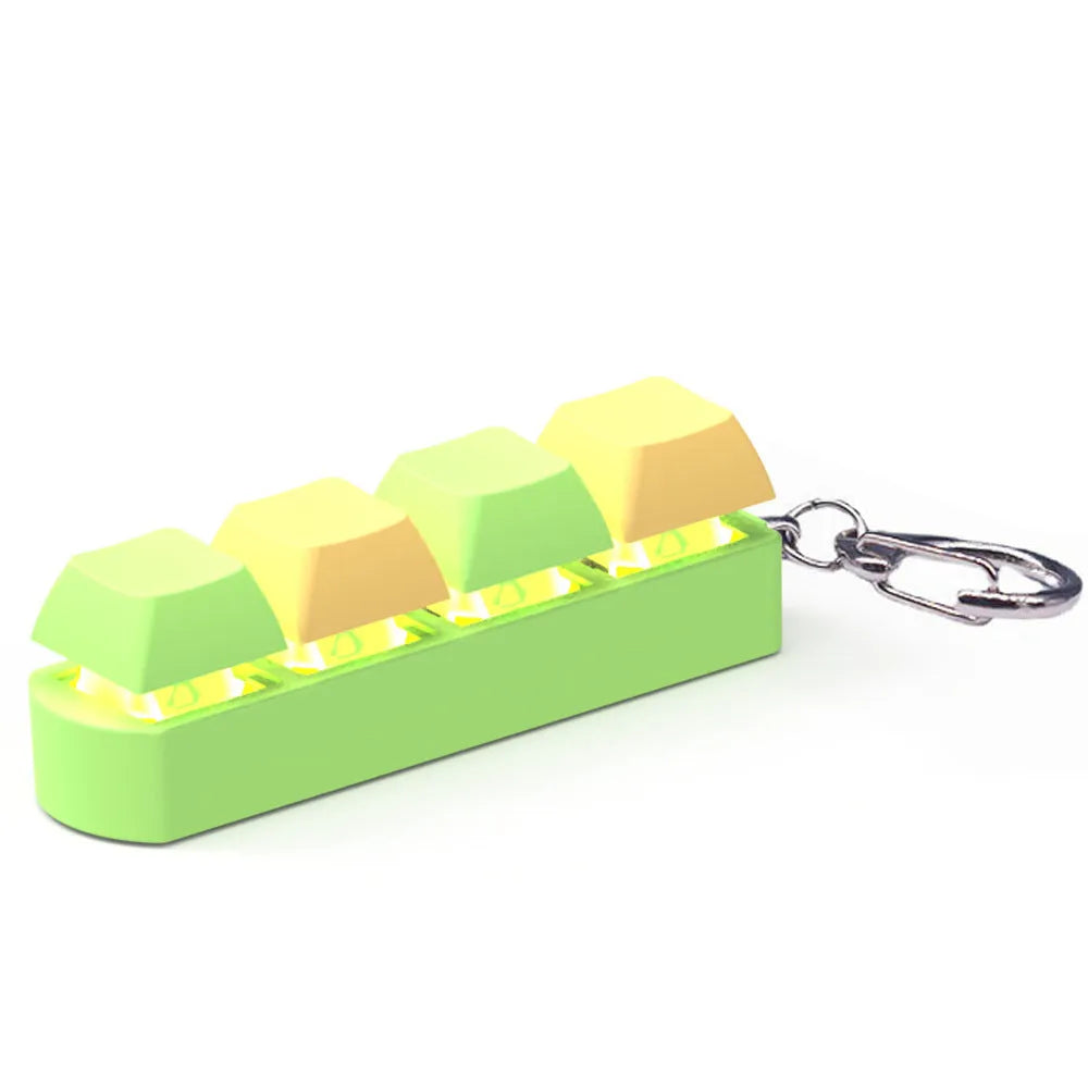 Four-key mechanical keyboard switch tester made of ABS plastic on a desk.