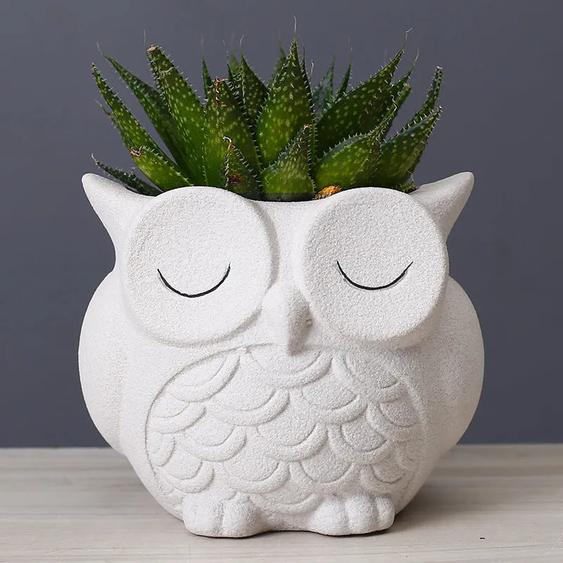 Handmade frosted ceramic flower pot with cartoon owl design, shown in light pink colour.