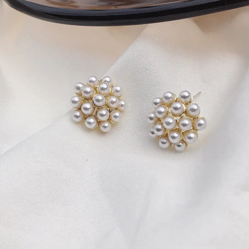 Gold Korean-style alloy earrings with pineapple starfish design and pearl-coloured gem inlays.