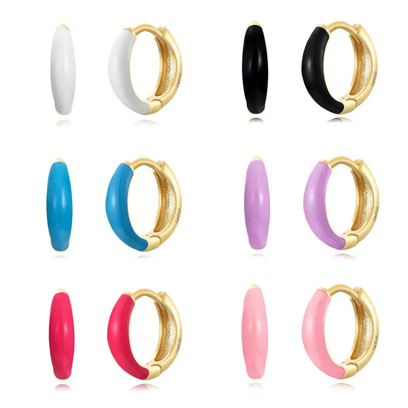 Geometric epoxy resin earrings with dripping oil colour technique showing oval curves and integrated rings