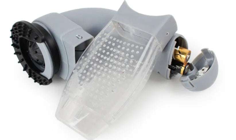 Grey handheld pet hair vacuum cleaner with soft rubber brush head for grooming dogs and cats.