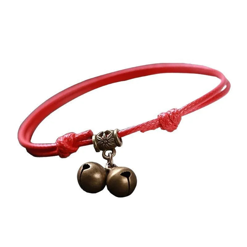 Small dog wearing adjustable nylon rope collar with brass bell in black, red, or coffee colour