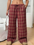 Women's red plaid loose trousers with drawstring waist and side pockets laid flat
