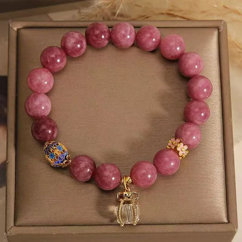 Women's natural stone bracelet with pearl pendant and pink lotus tassel on wrist
