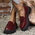 Women's black slip-on loafers with chunky platform heel and solid colour design