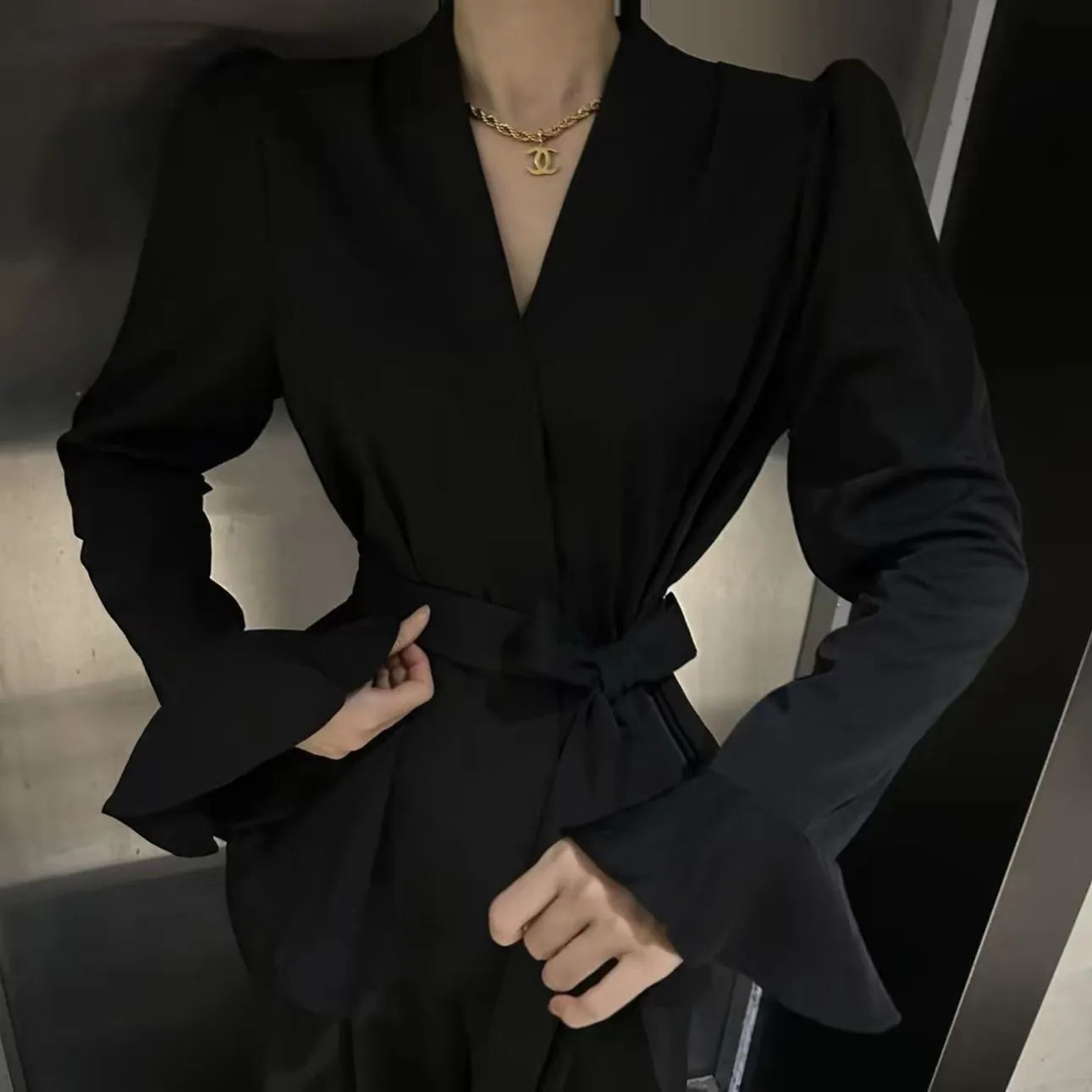 Women's French-style irregular collar shirt with long bell sleeves and tie front detail in polyester fabric.