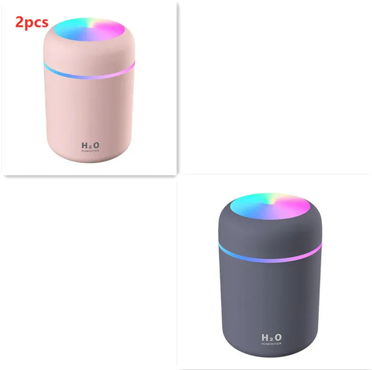 Pink USB portable humidifier with 300ml water tank on wooden desk surface