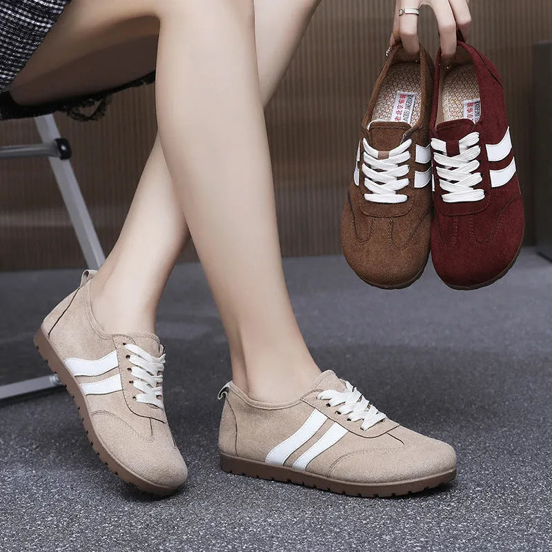 Women's vintage canvas sneakers in dark red with a round toe and soft rubber sole.