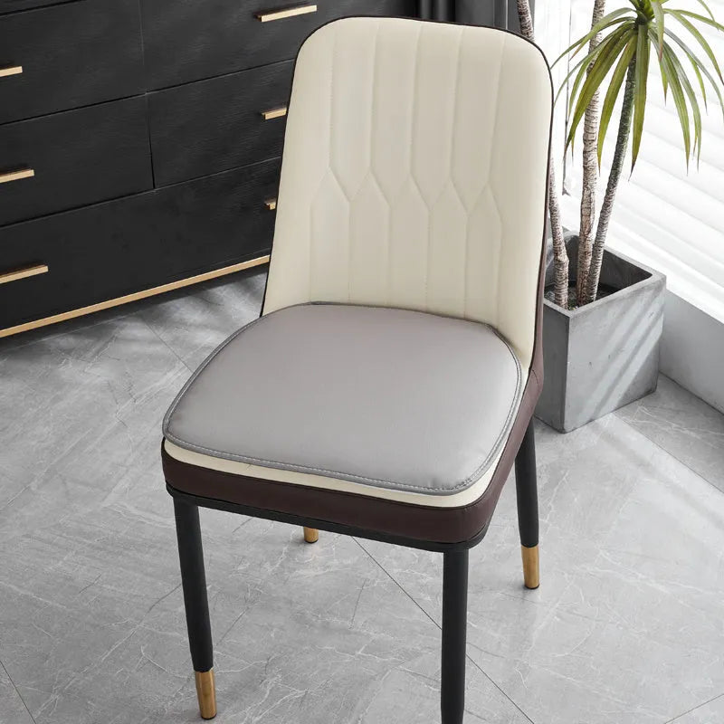 Horseshoe-shaped PU leather seat cushion in orange, shown on a chair.