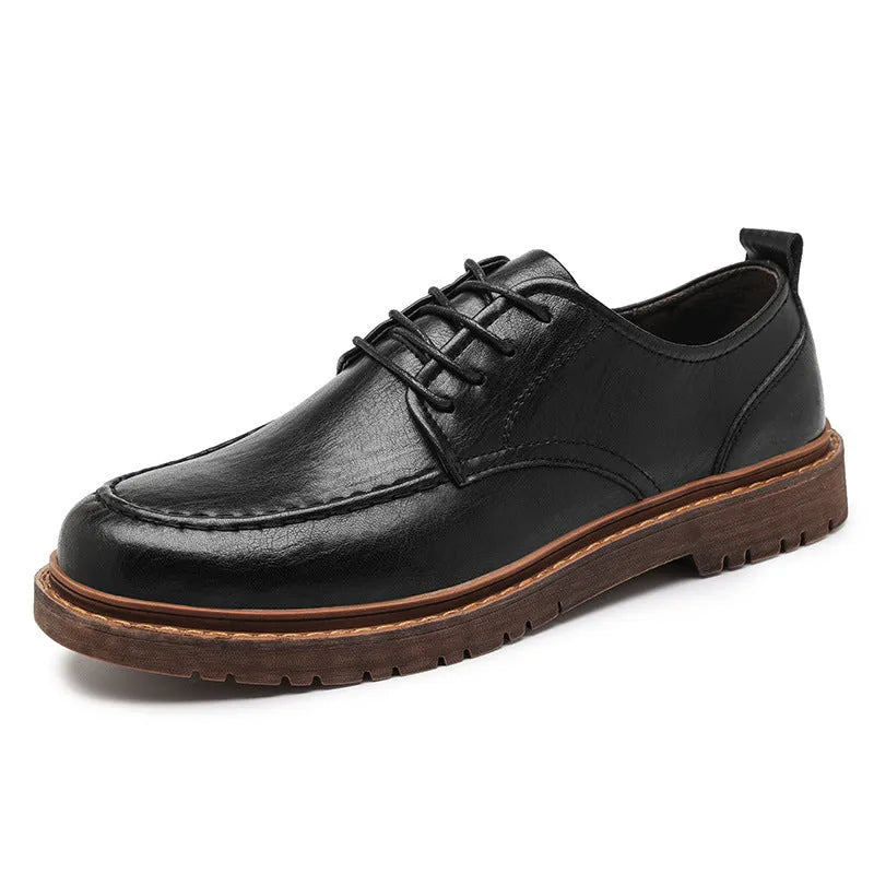 Men's black casual leather shoes with sewing line details and a round toe on a flat rubber sole.