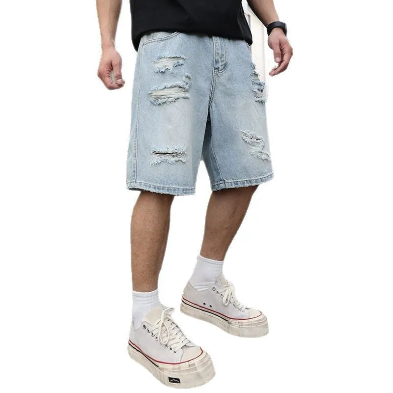 Light blue ripped denim shorts with distressed detailing and loose straight cut fit