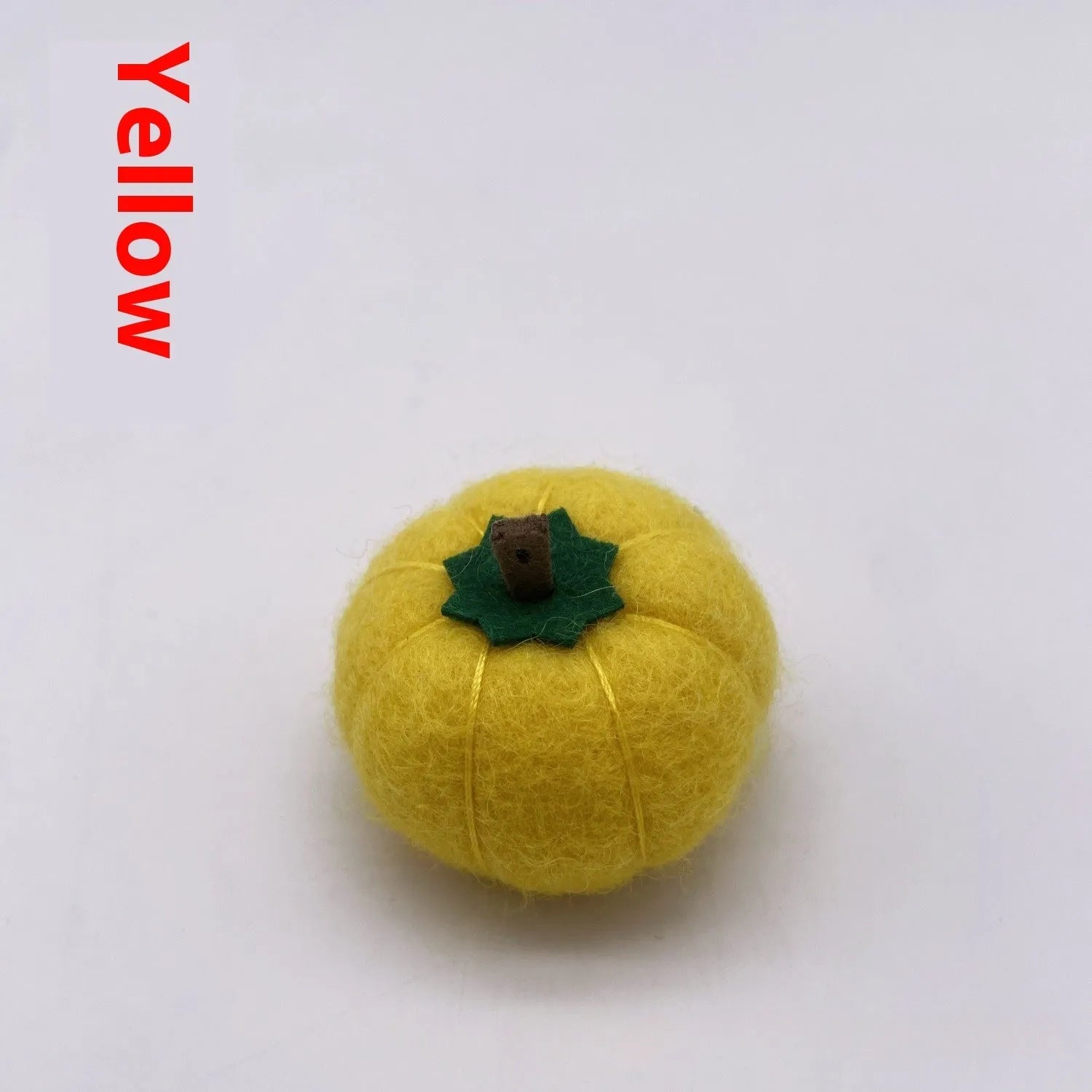 Wool felt pumpkin ornament in assorted colours for dollhouse decoration, approx. 5cm wide.
